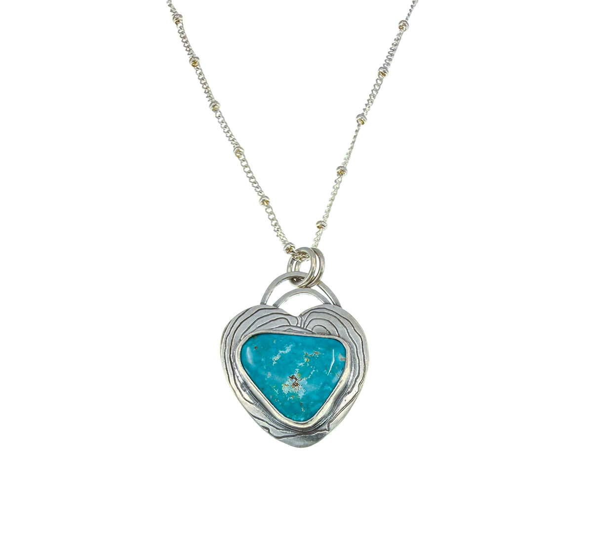 Turquoise heart-shaped pendant on a silver chain against a white background